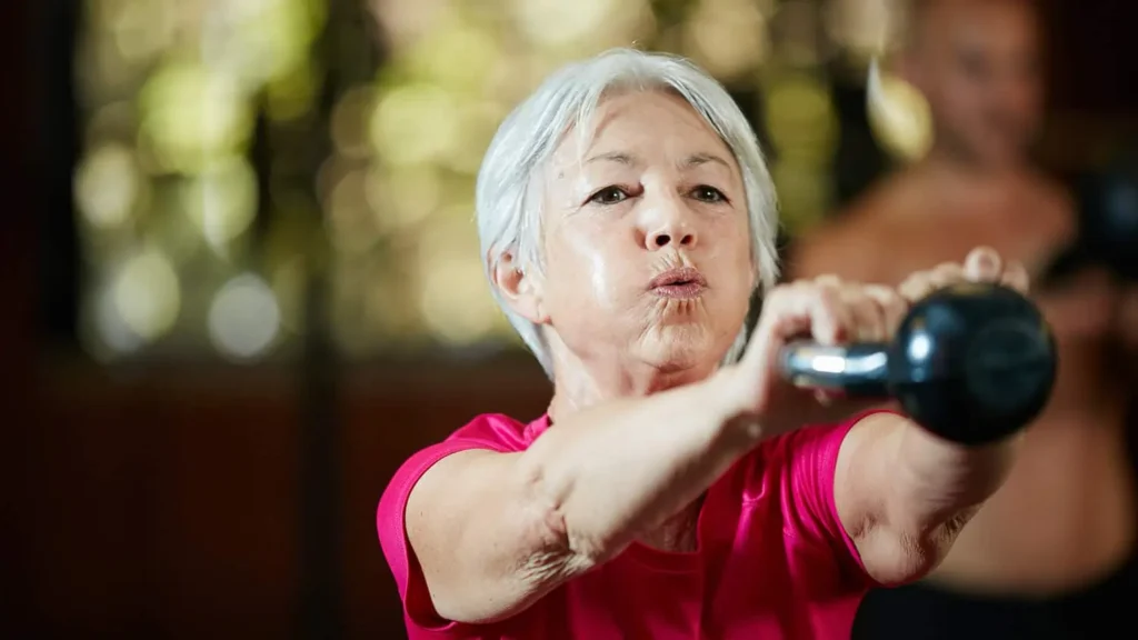 Toning Arms Without the Bulk: Is It Achievable? 1 Woman doing resistance band exercises for toned arms Hastings
